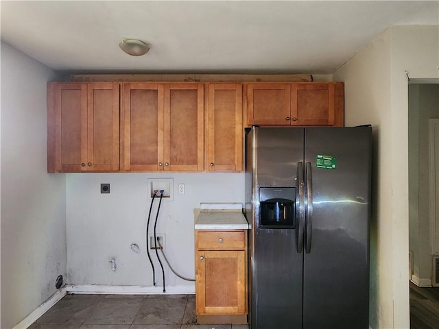 kitchen featuring stainless steel refrigerator with ice dispenser