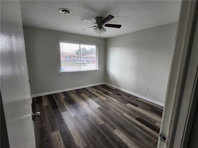 empty room featuring ceiling fan and dark hardwood / wood-style floors