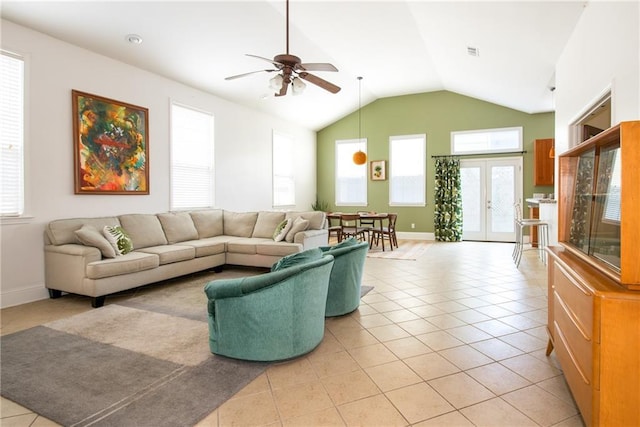 tiled living room featuring lofted ceiling, ceiling fan, and french doors