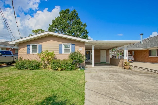 single story home featuring a carport, a front lawn, concrete driveway, and brick siding