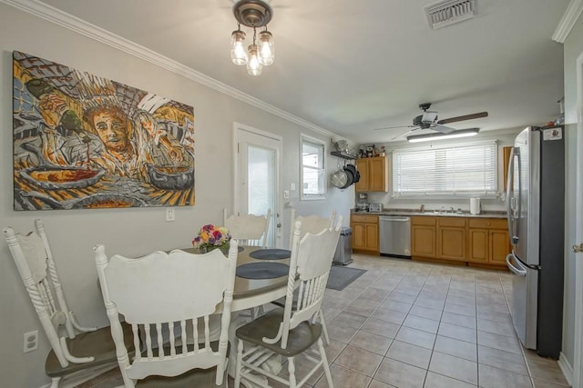 dining room with light tile patterned floors, ceiling fan, visible vents, and ornamental molding