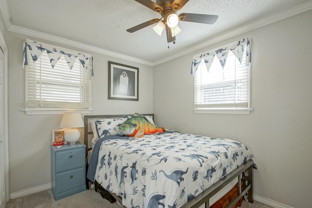 bedroom with baseboards, ornamental molding, ceiling fan, and carpet flooring