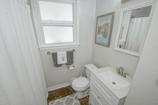 full bathroom featuring vanity, toilet, and baseboards