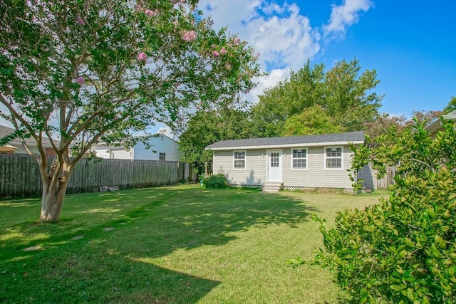 view of yard with entry steps and fence