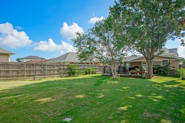 view of yard featuring fence and a wooden deck