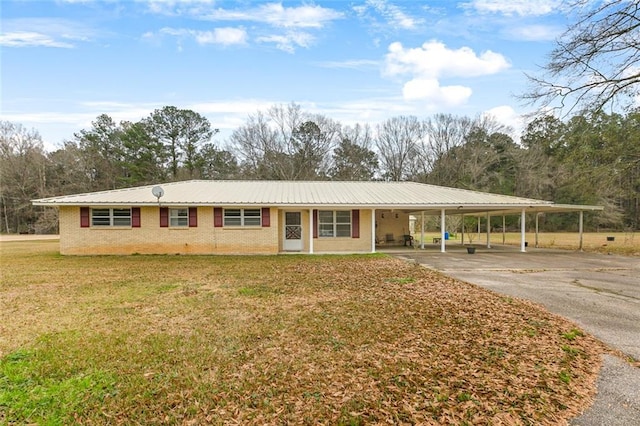 view of front facade with a carport and a front lawn