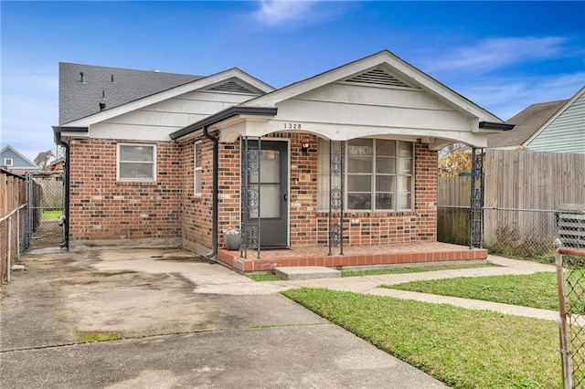 bungalow with a front yard and covered porch