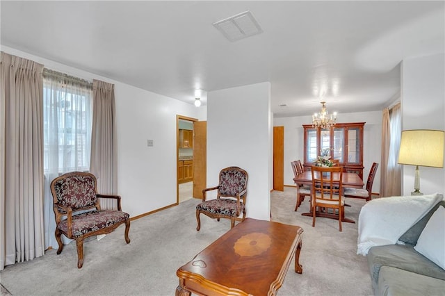 living room with light carpet, a chandelier, and a healthy amount of sunlight