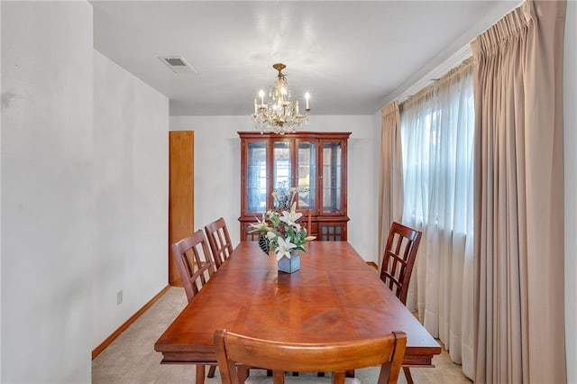 carpeted dining area with a notable chandelier