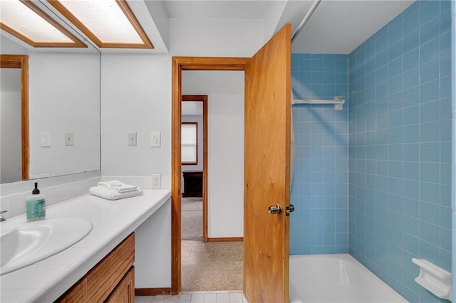 bathroom with vanity and tiled shower / bath combo