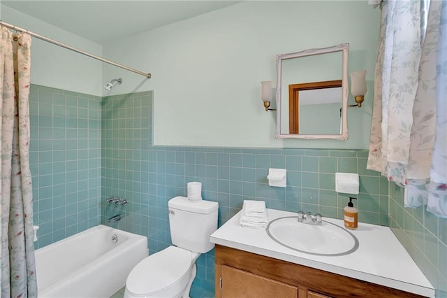 full bathroom with vanity, toilet, shower / tub combo, and tile walls