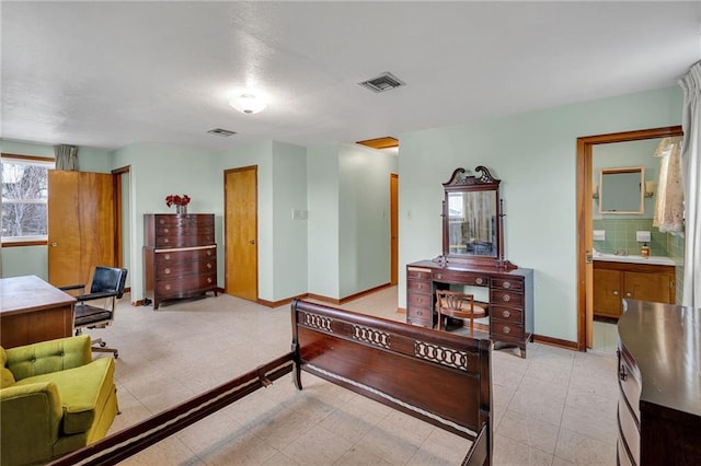 1328 Clouet St, New Orleans, LA 70117 - bedroom featuring baseboards and ensuite bath