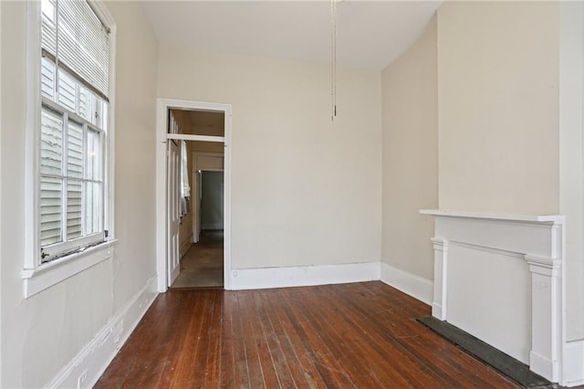 unfurnished living room with dark hardwood / wood-style floors