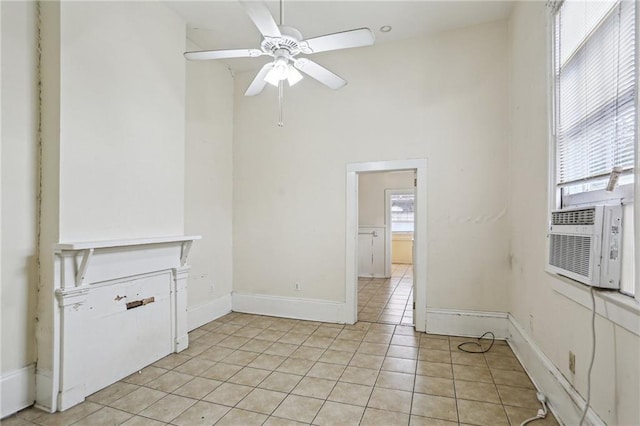 tiled empty room with cooling unit, ceiling fan, and a towering ceiling