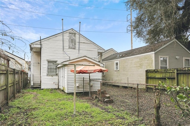 back of property with an outbuilding