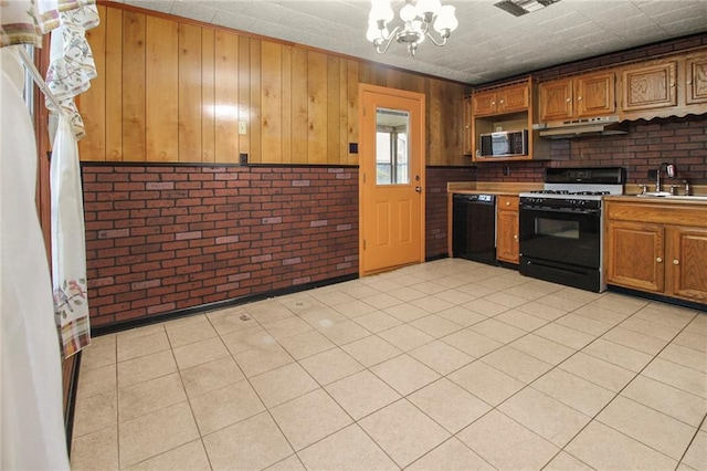 kitchen featuring brick wall, black dishwasher, sink, a chandelier, and gas range