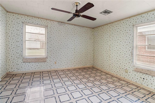 unfurnished room featuring ceiling fan and plenty of natural light