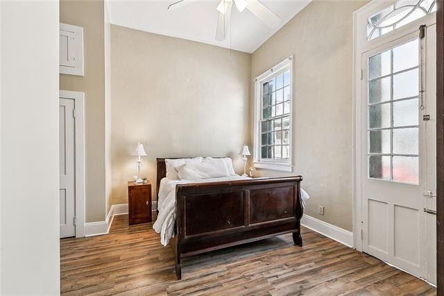 1224 Bourbon St Unit 1, New Orleans, LA 70116 - bedroom featuring wood finished floors, baseboards, and a ceiling fan