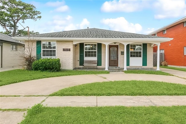 ranch-style house featuring a porch and a front lawn