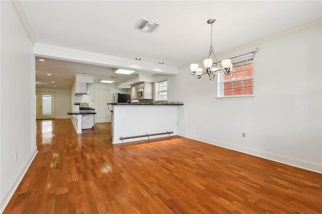 interior space featuring pendant lighting, refrigerator, white cabinetry, dark hardwood / wood-style flooring, and kitchen peninsula