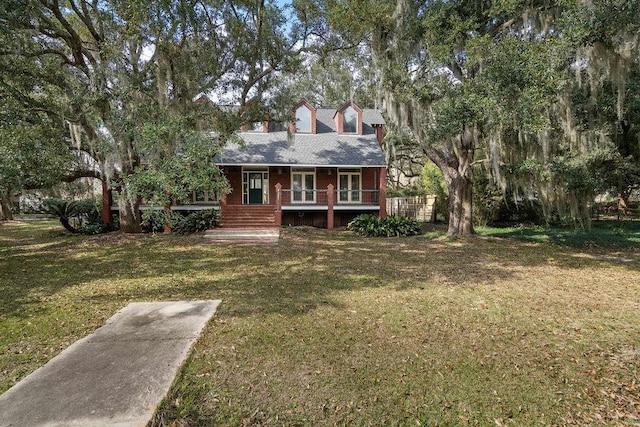 rear view of property with a porch and a lawn