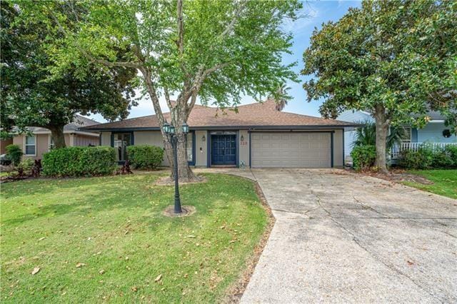 ranch-style home with a garage and a front yard