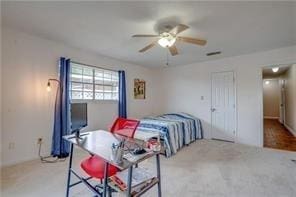 bedroom featuring light carpet and ceiling fan