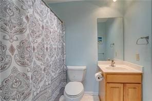 bathroom with vanity, curtained shower, and toilet