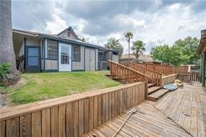 wooden terrace featuring a yard