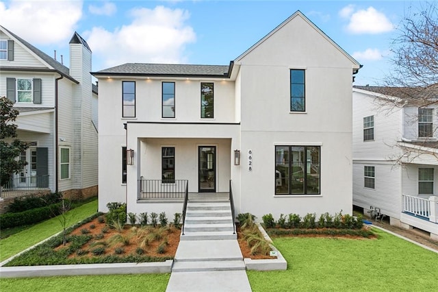 view of front of property with a porch and a front lawn