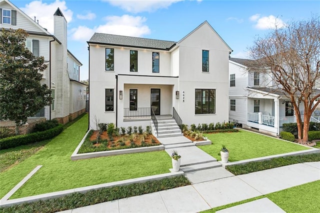 view of front of property featuring covered porch and a front lawn