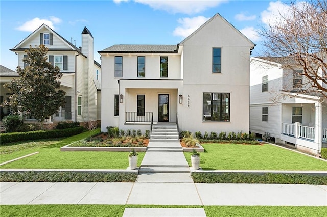 view of front of home featuring a front lawn and stucco siding