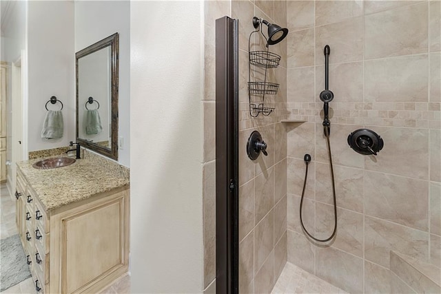 bathroom with vanity and a tile shower