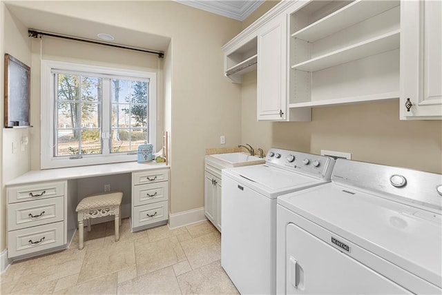 laundry room with cabinets, crown molding, washer and dryer, and sink