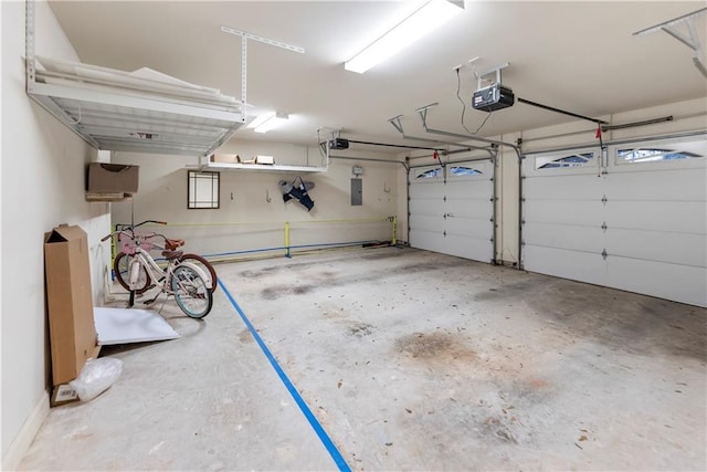 garage with a garage door opener and electric panel