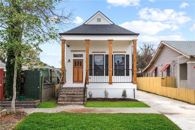 423 Diana St, New Orleans, LA 70114 - shotgun-style home featuring roof with shingles and a porch