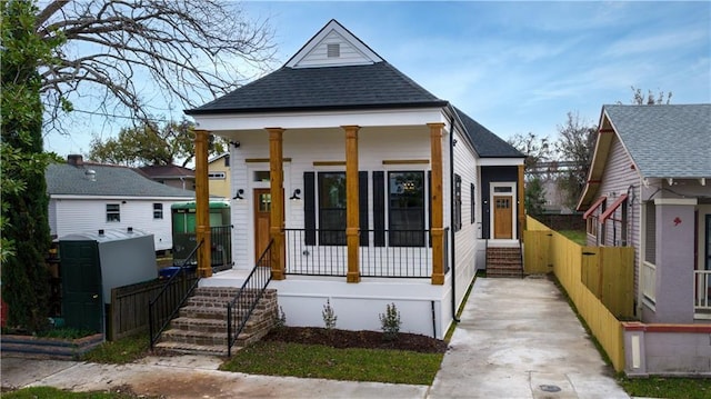 423 Diana St, New Orleans, LA 70114 - shotgun-style home with a porch and a shingled roof