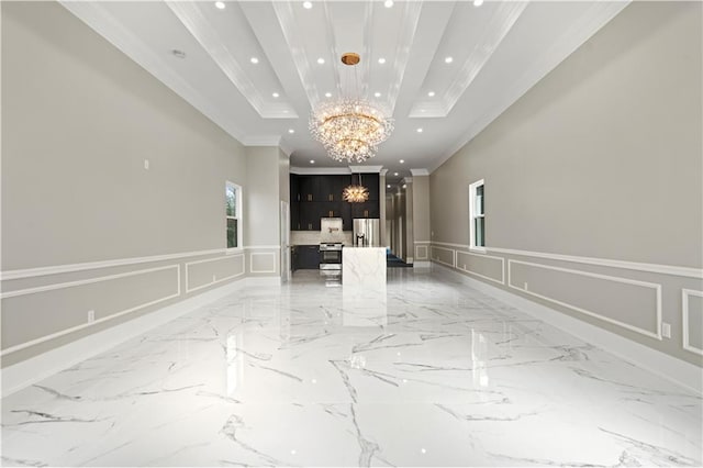 interior space featuring crown molding, a raised ceiling, and a chandelier