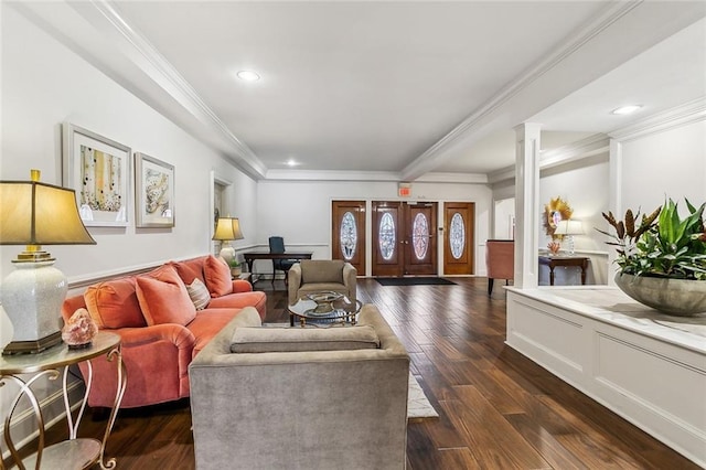 living room featuring decorative columns, crown molding, and dark hardwood / wood-style floors