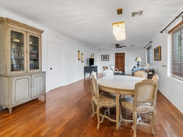 dining area with hardwood / wood-style floors and ceiling fan