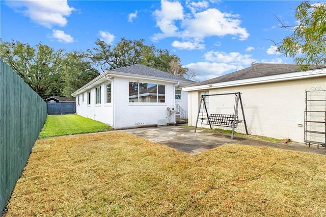 rear view of house with a yard and a patio area