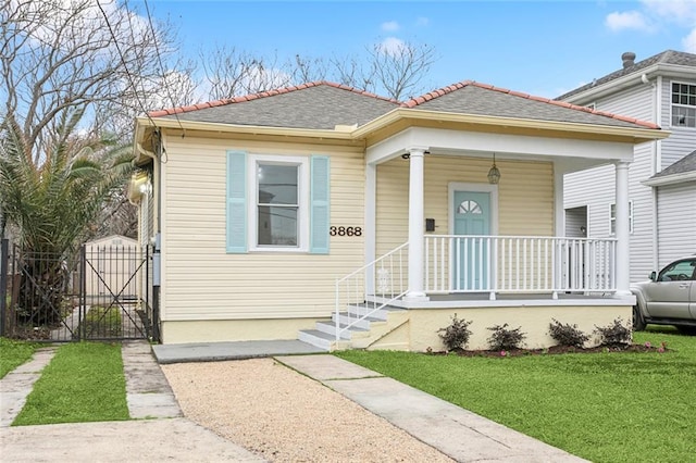 bungalow featuring a porch and a front yard