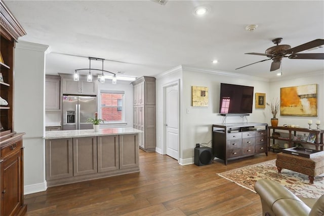 kitchen featuring stainless steel refrigerator with ice dispenser, crown molding, decorative light fixtures, dark hardwood / wood-style flooring, and ceiling fan