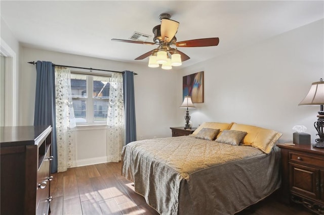 bedroom with dark wood-type flooring and ceiling fan