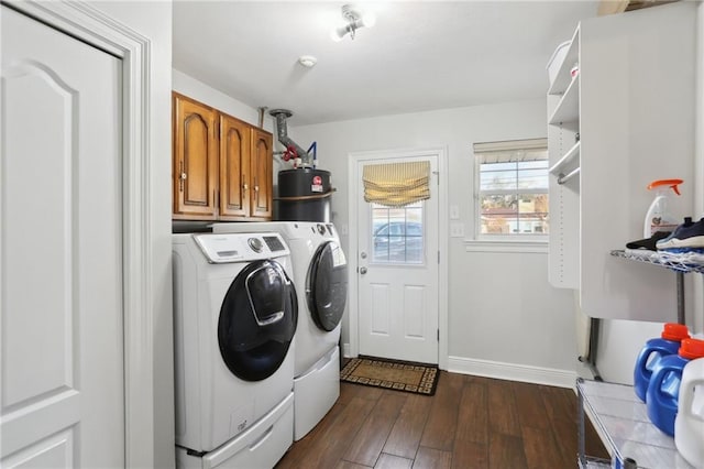 laundry room with dark hardwood / wood-style flooring, cabinets, water heater, and washing machine and clothes dryer