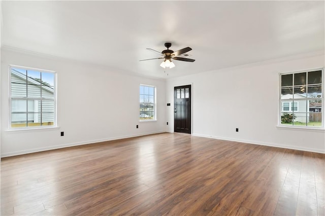 empty room featuring ceiling fan, ornamental molding, and dark hardwood / wood-style flooring