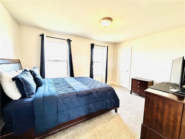 bedroom featuring light carpet