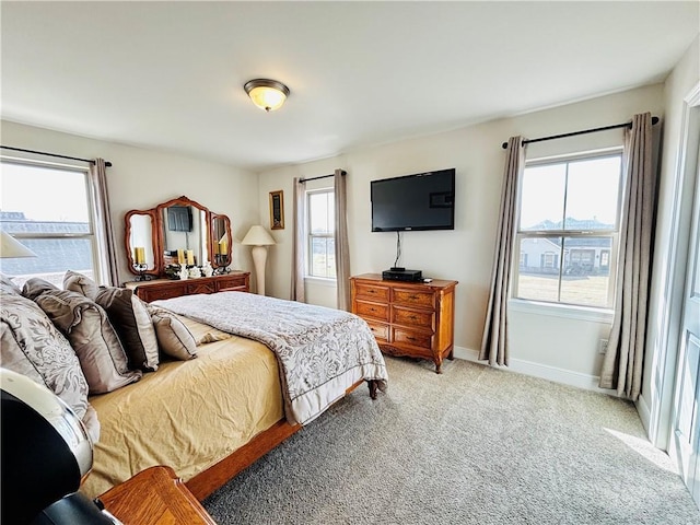 carpeted bedroom featuring multiple windows