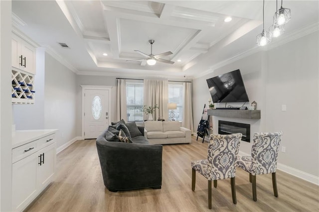 living room featuring coffered ceiling, light hardwood / wood-style flooring, and ornamental molding