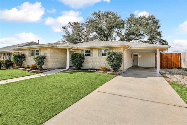 3512 James Dr, Metairie, LA 70003 - ranch-style house with fence, a front lawn, brick siding, an attached carport, and driveway